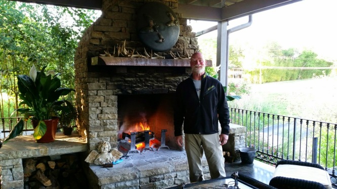 Jerry in front of the patio fireplace