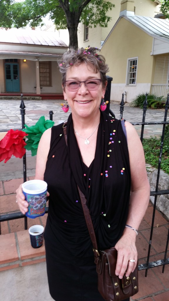 Cascarones are a Fiesta tradition. Egg shells, colorfully painted and filled with confetti, to crack on your friends' heads. Note my Cascarone earrings. :-)